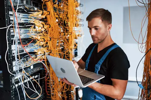 Engineer installing and configuring network equipment